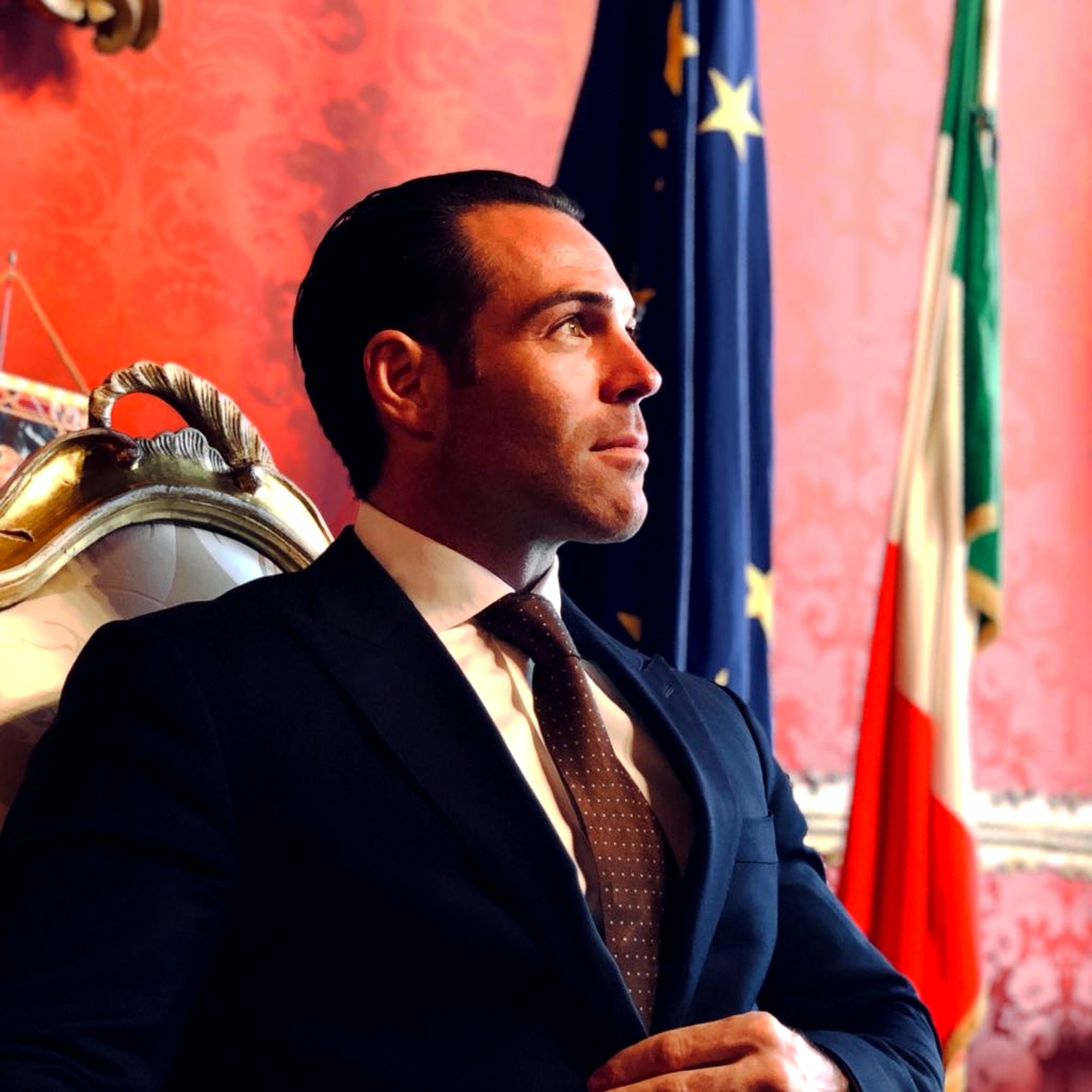 Massimiliano 'Max' Musina, Italian-American film producer, in the Veneto regional government room, Venice, with Italian, EU, and Veneto regional flags